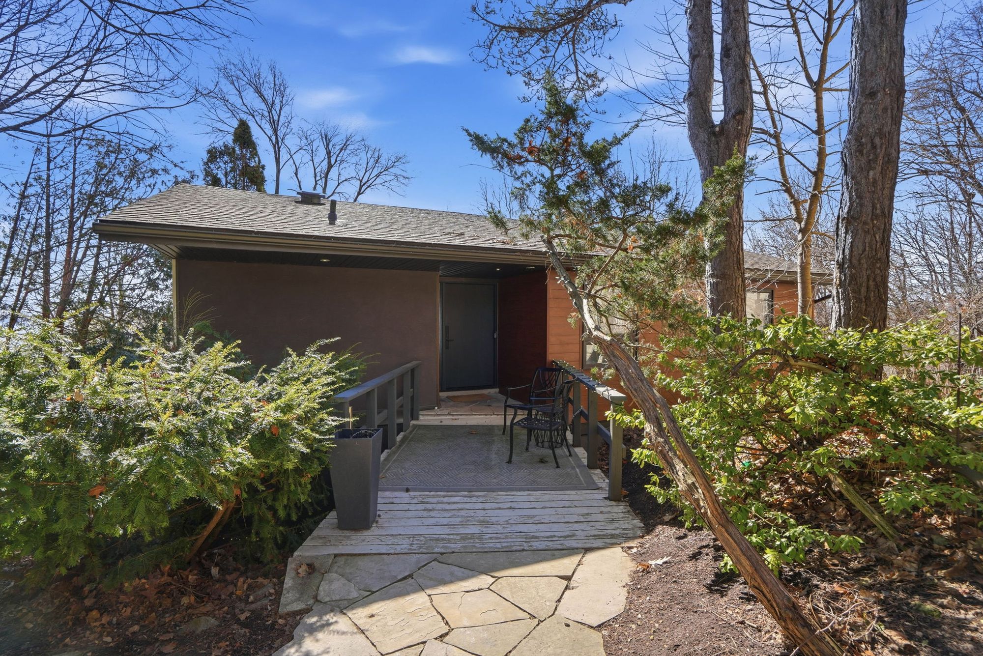 The front walk and the entry under the pines