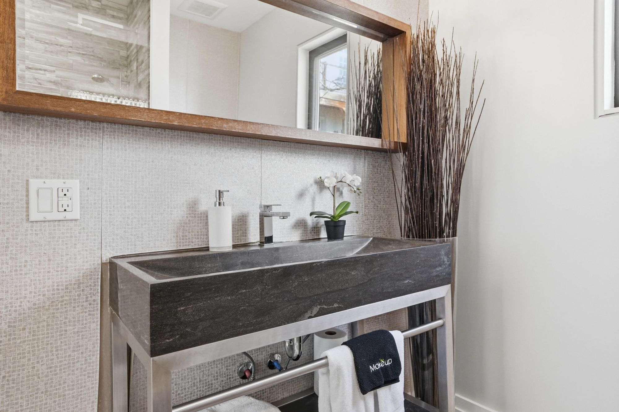 A bathroom with a stone vessel vanity