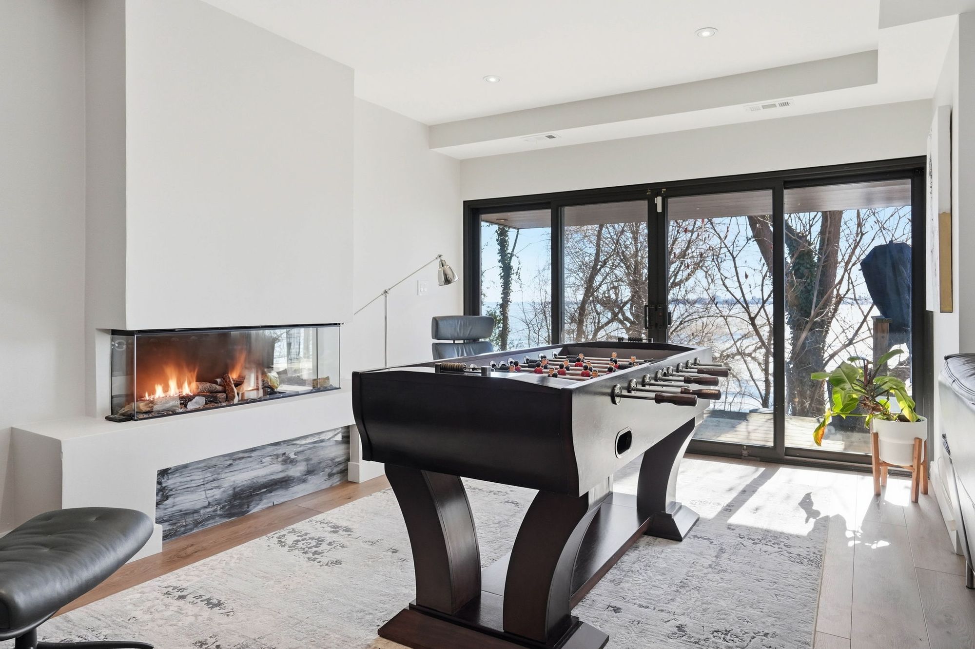 The three-sided fireplace in the rec room
