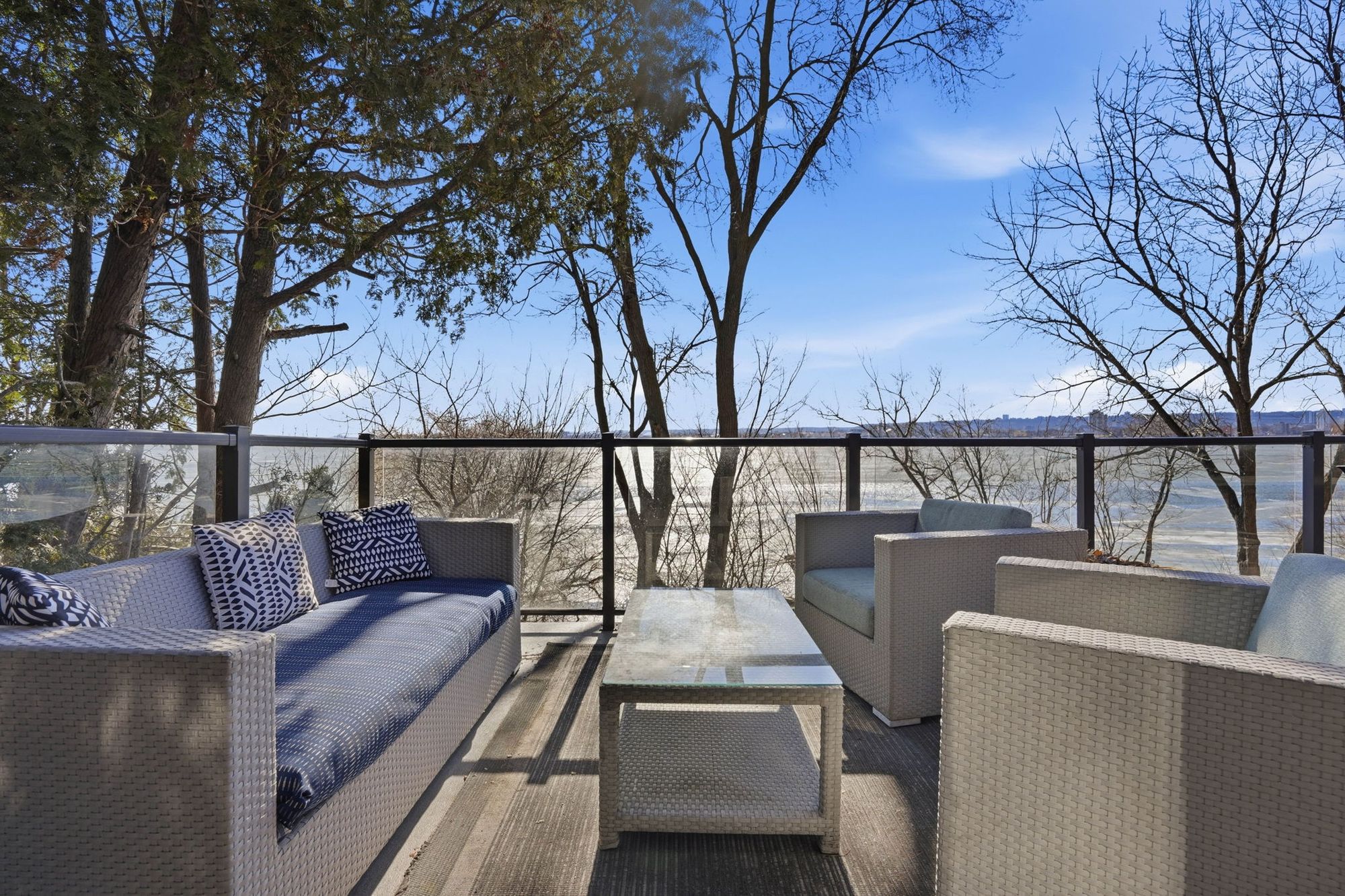 The upper deck lounge with glass railings and the bay beyond