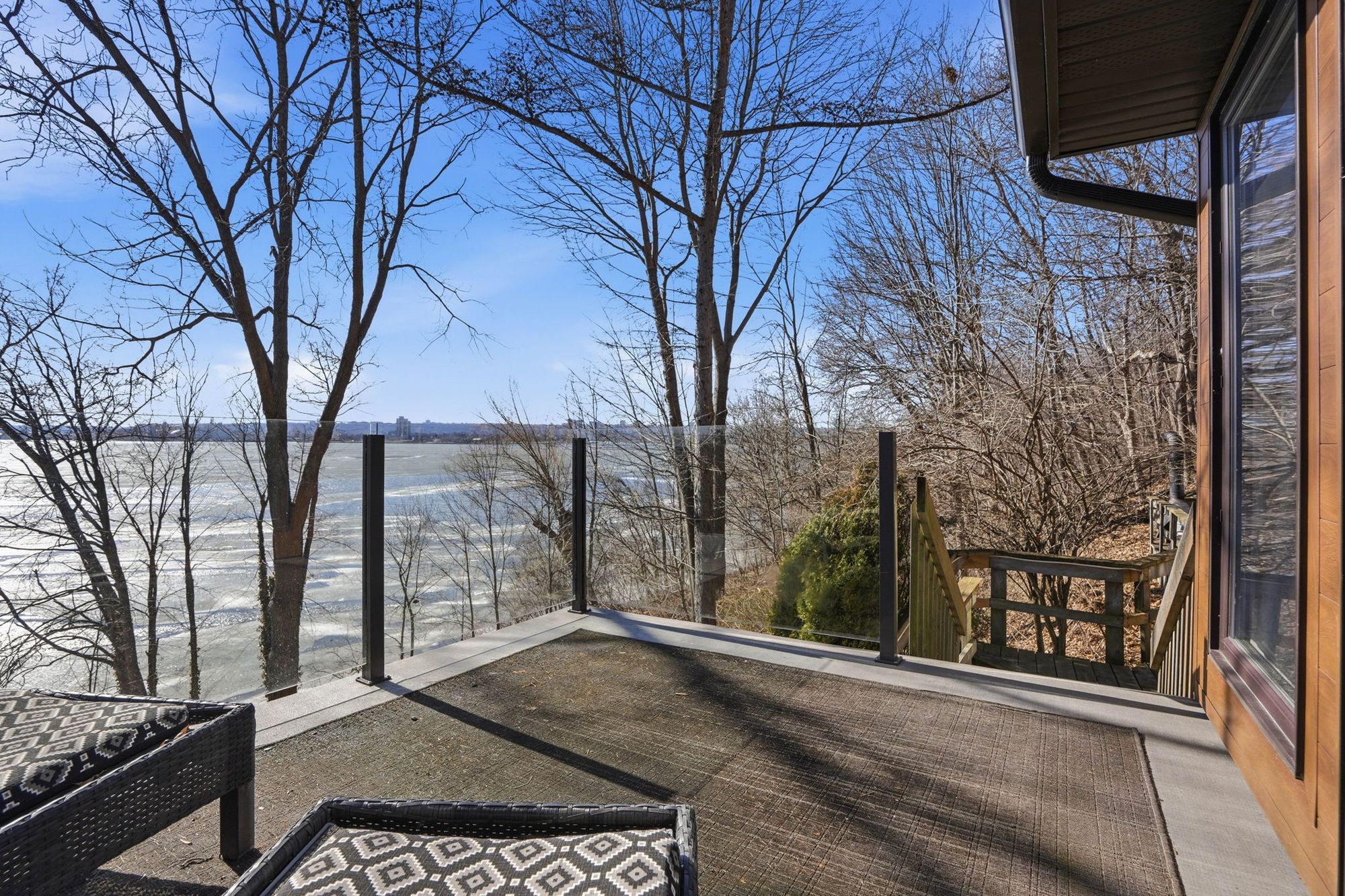 A balcony looking out over the trees to the water