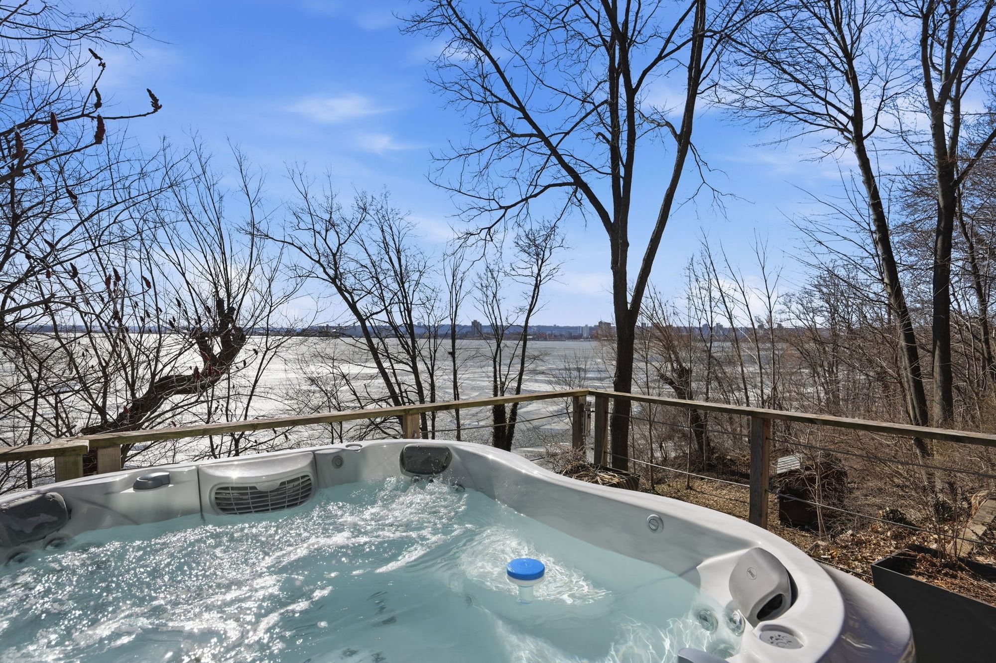 The hot tub with the bay through the trees