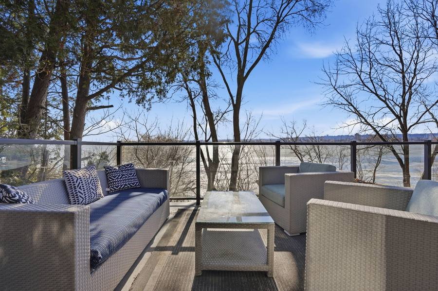 The upper deck lounge with glass railings and the bay beyond