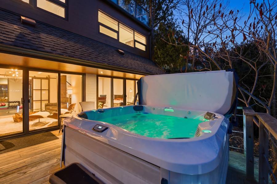 The hot tub glowing on the deck at dusk