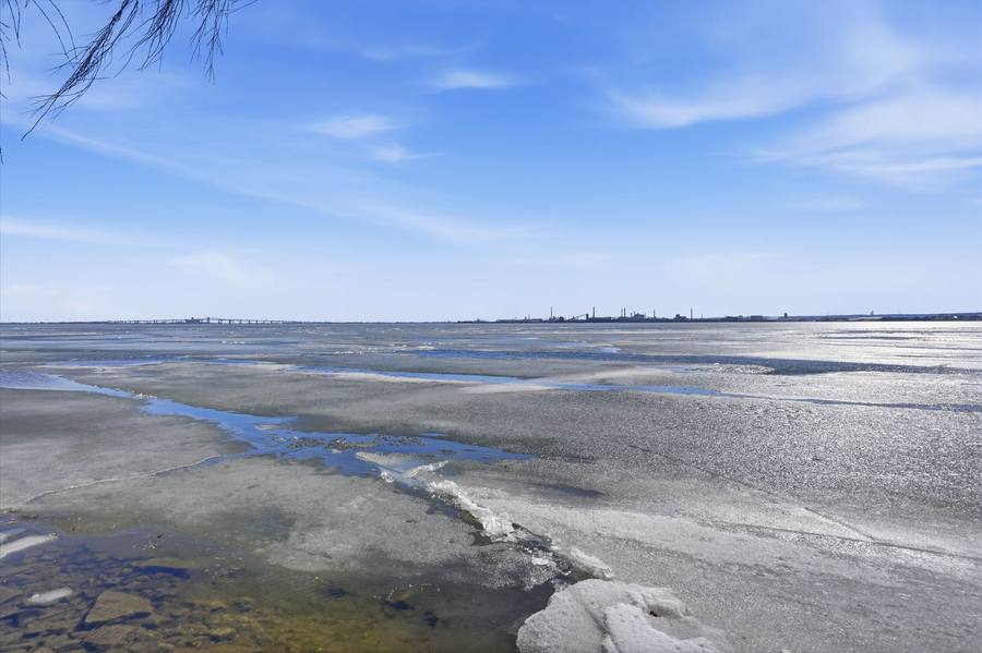 Ice on the bay in winter, looking across to the far shore